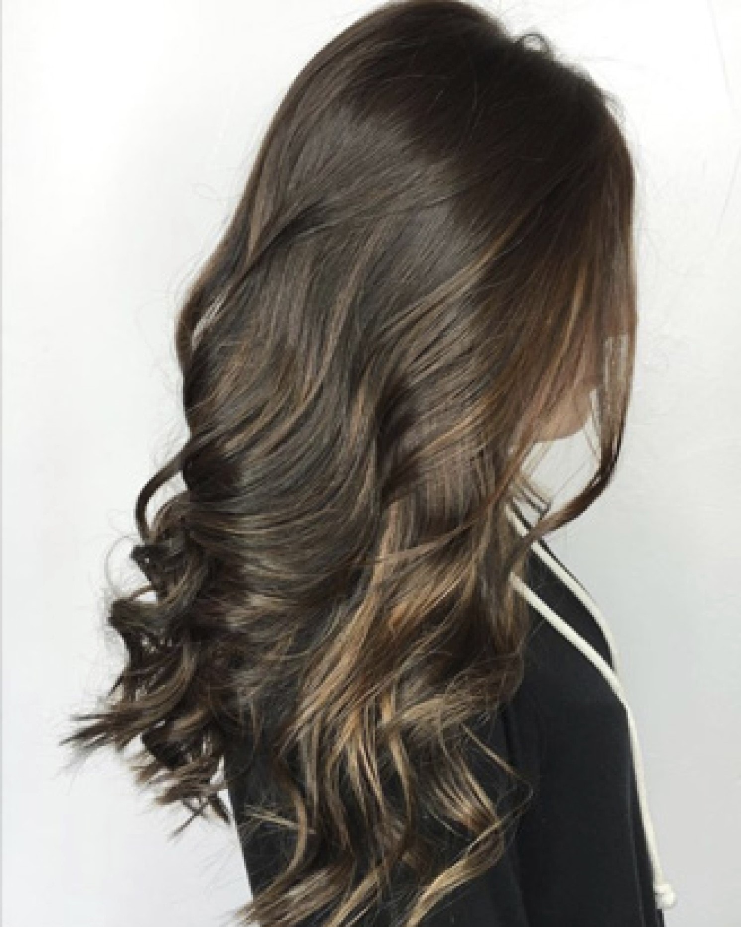 Shiny curled long brunette brown hair